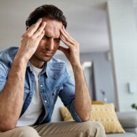 Man holding his head while having bad headache